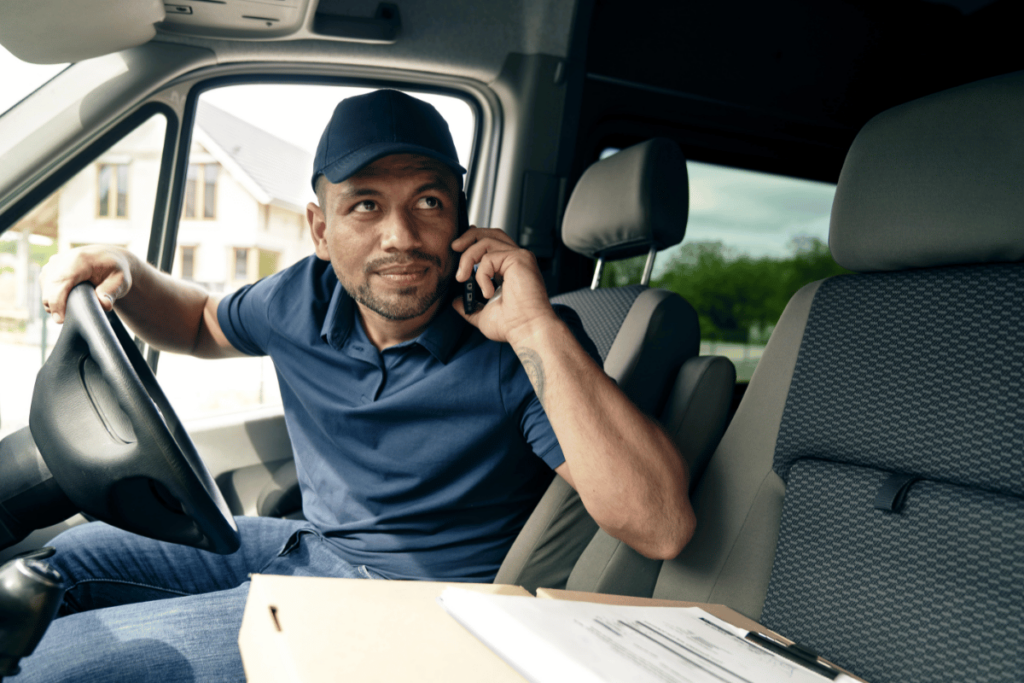 delivery driver looking out of the window of his van.