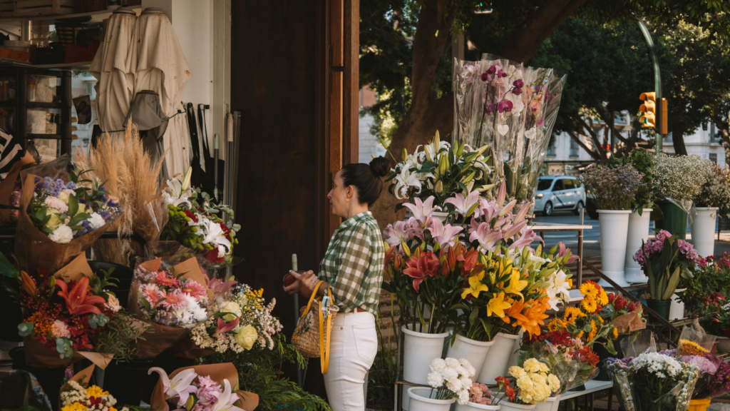 woman standing outside of a flower shop